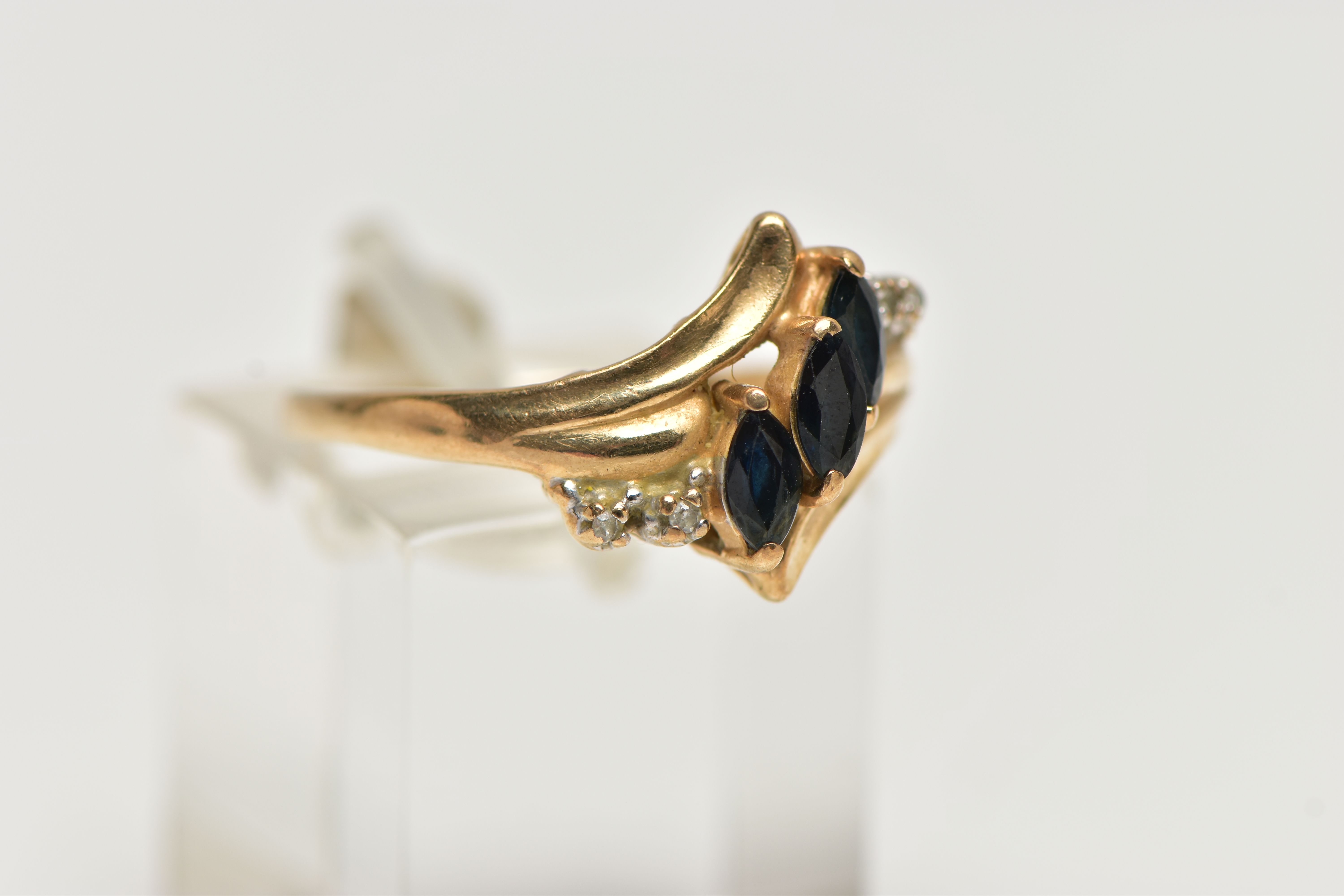 A YELLOW METAL GEMSET DRESS RING, three marquise cut sapphires accented with four single cut - Image 4 of 4