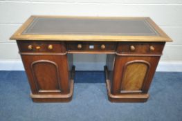 A VICTORIAN WALNUT KNEE HOLE DESK, with a brown leather writing surface, three frieze drawers,