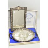 A LATE VICTORIAN SILVER FRAMED VANITY TABLE MIRROR AND A SILVER PLATED SERVING TRAY, the rectangular