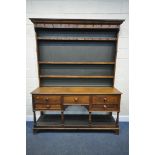 A GEORGIAN OAK DRESSER, the top with three shelves, various hooks, on a base with five drawers, on