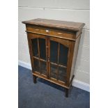 AN EARLY 20TH CENTURY OAK GLAZED TWO DOOR BOOKCASE, on square legs, width 74cm x depth 33cm x height