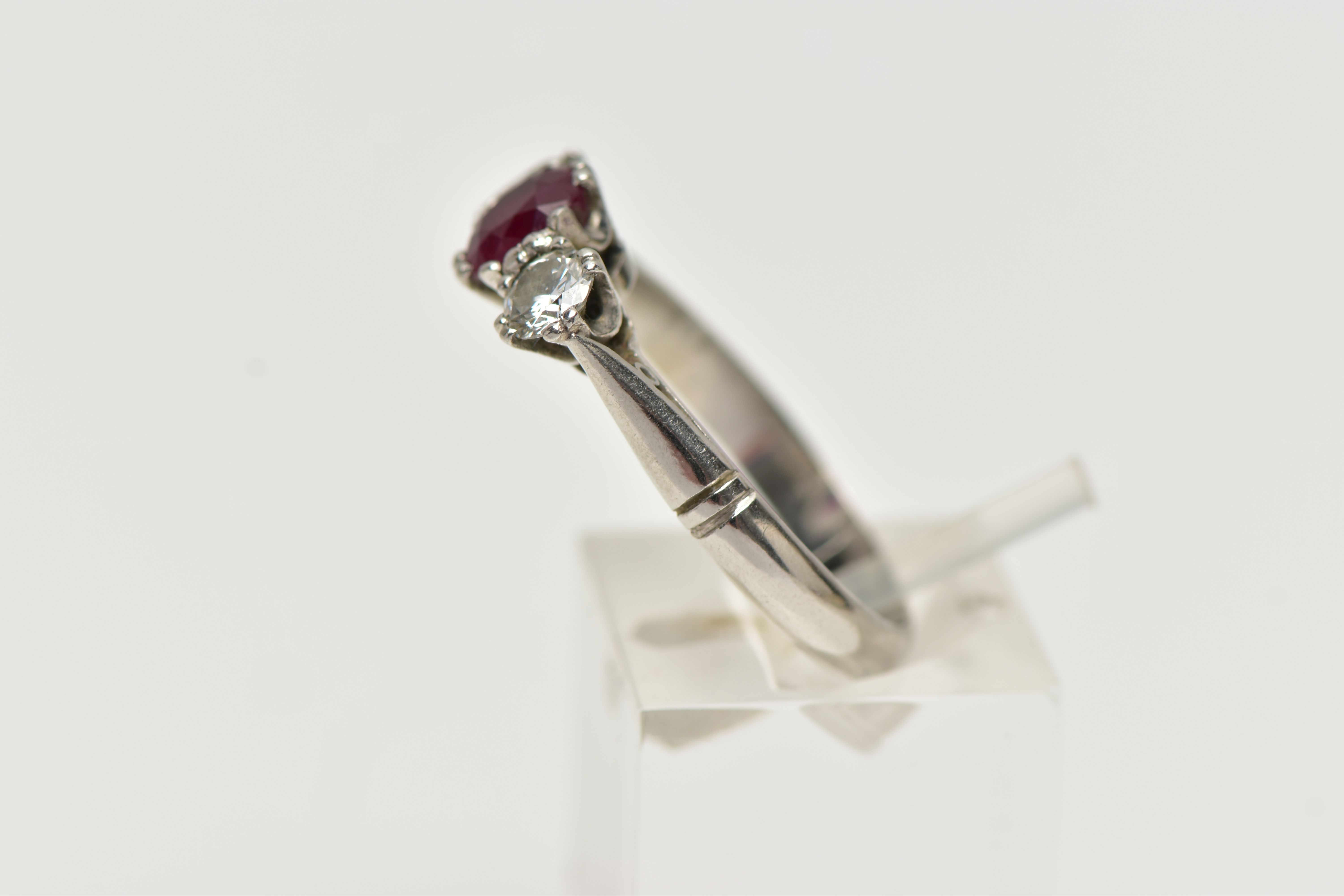 A PLATINUM RUBY AND DIAMOND THREE STONE RING, centering on an oval cut ruby, - Image 2 of 4