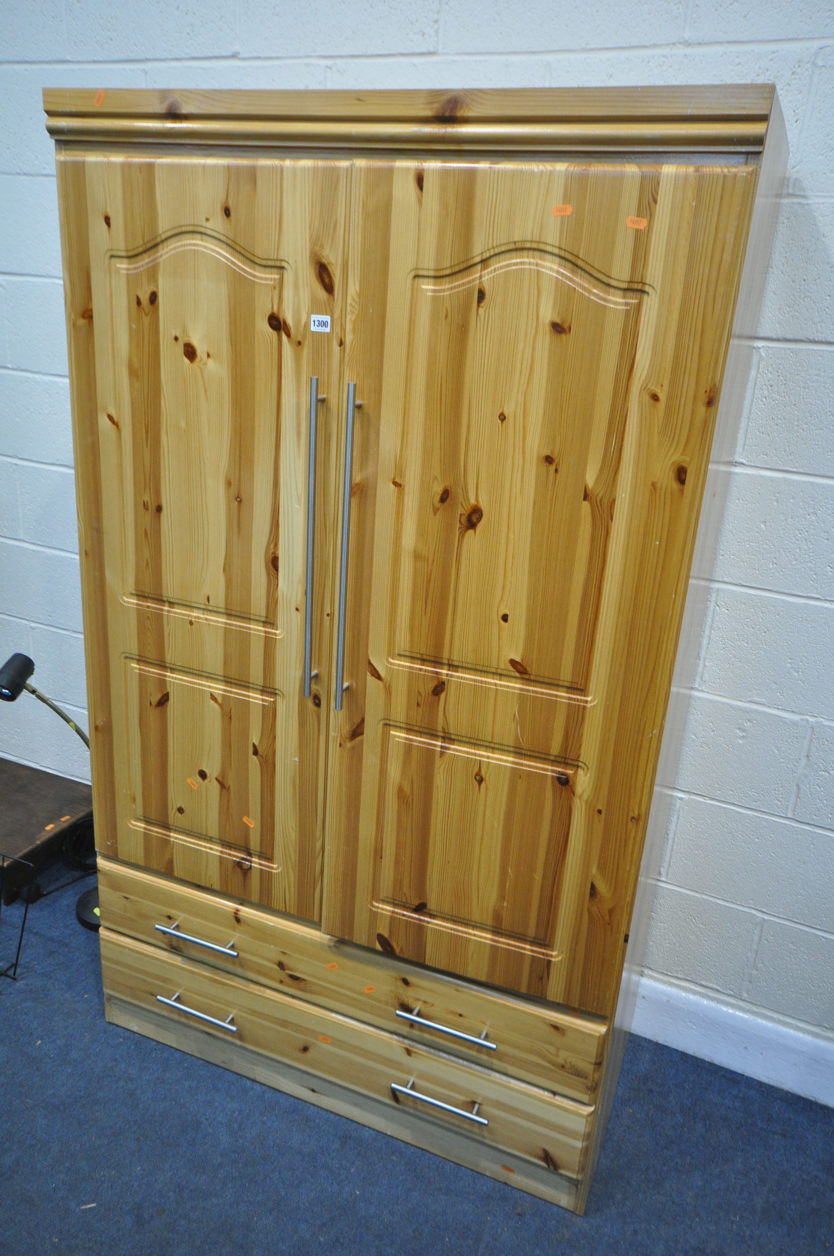 A MODERN PINE DOUBLE DOOR WARDROBE, with two drawers, width 107cm x depth 57cm x height 181cm (