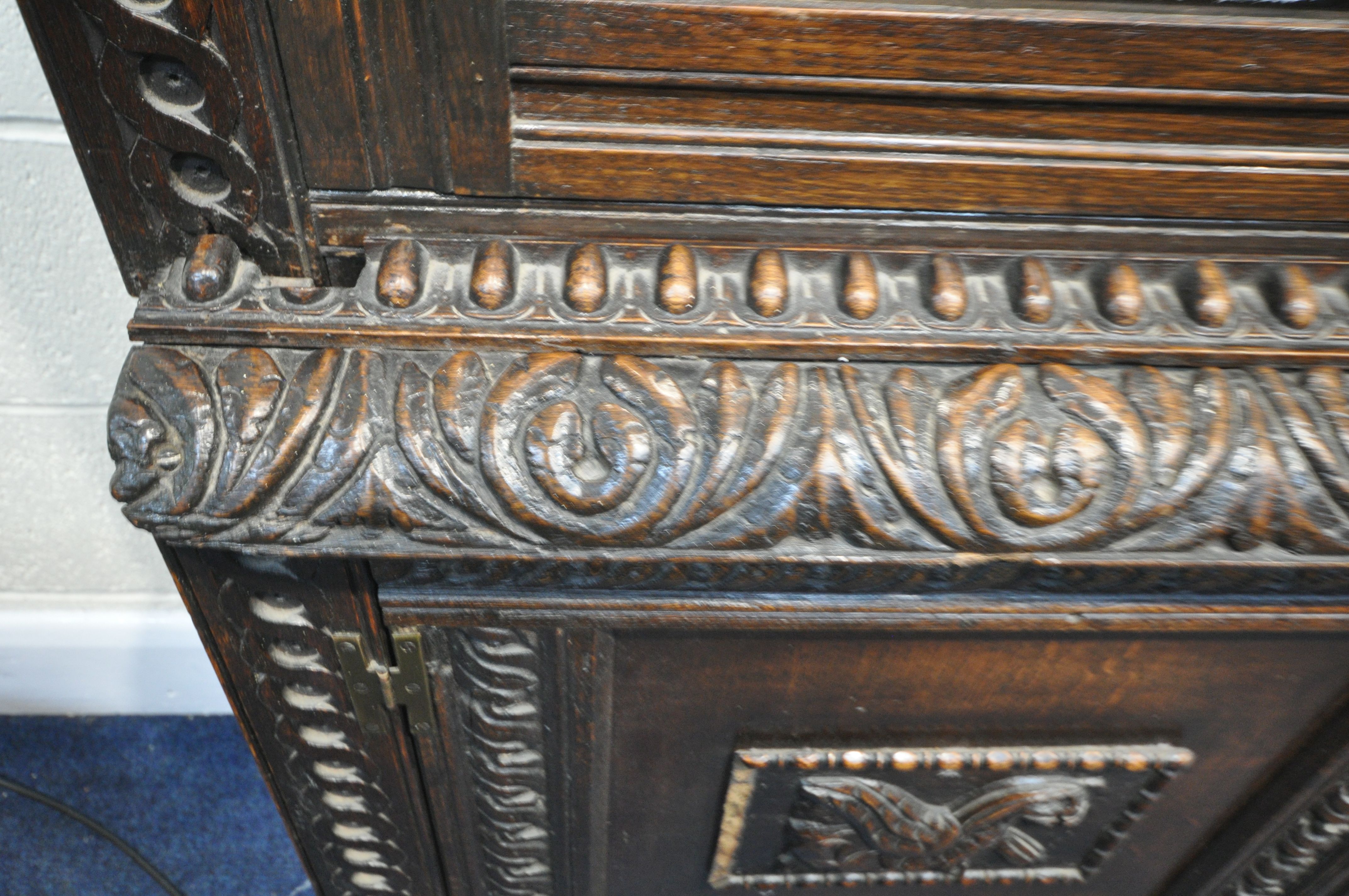 A CARVED OAK BOOKCASE, with double glazed doors that's enclosing three adjustable shelves, on a base - Image 4 of 4