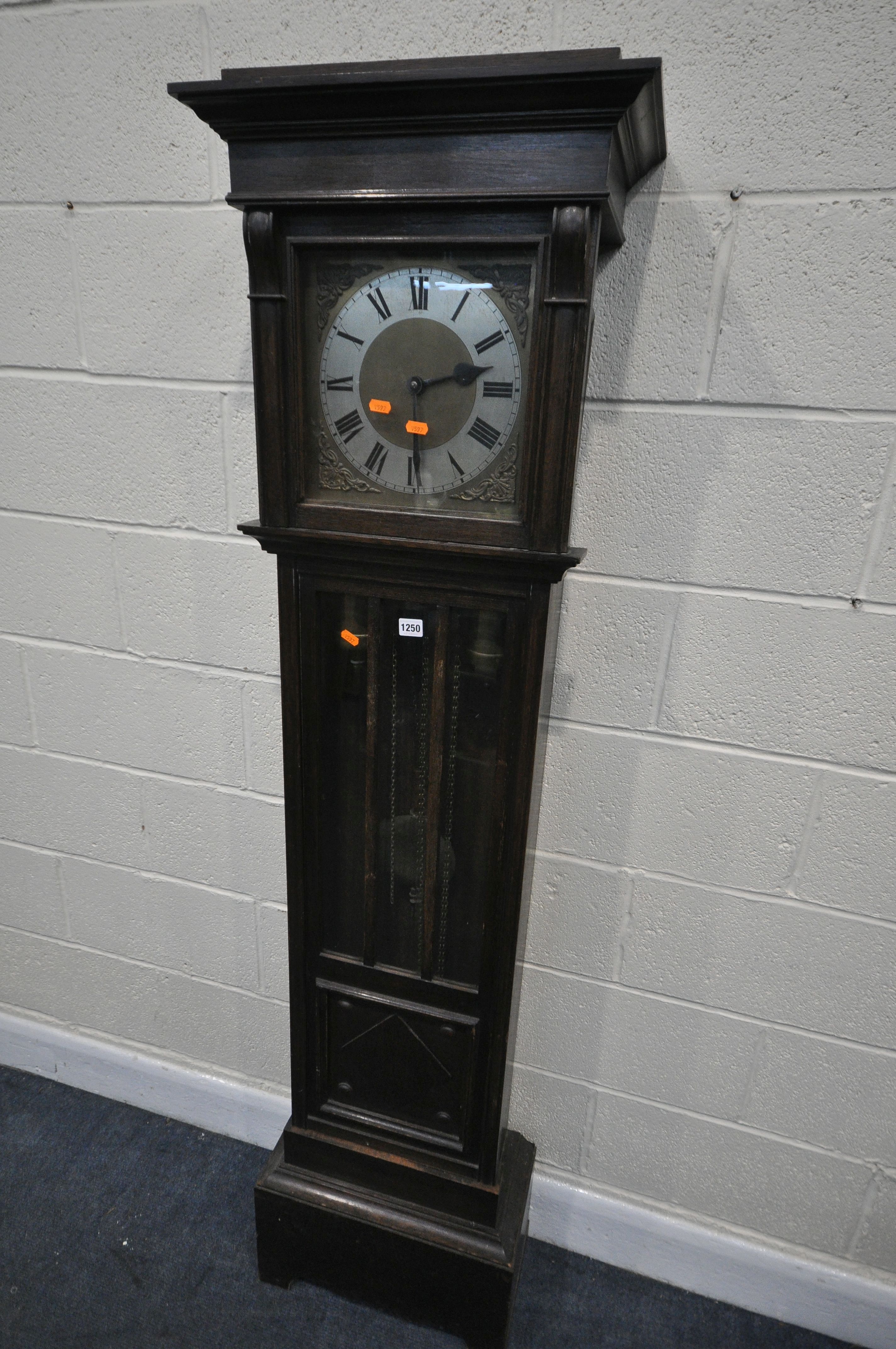 AN EARLY TO MID 20TH CENTURY OAK CHIMING LONGCASE CLOCK, with a brass and silvered dial, and roman