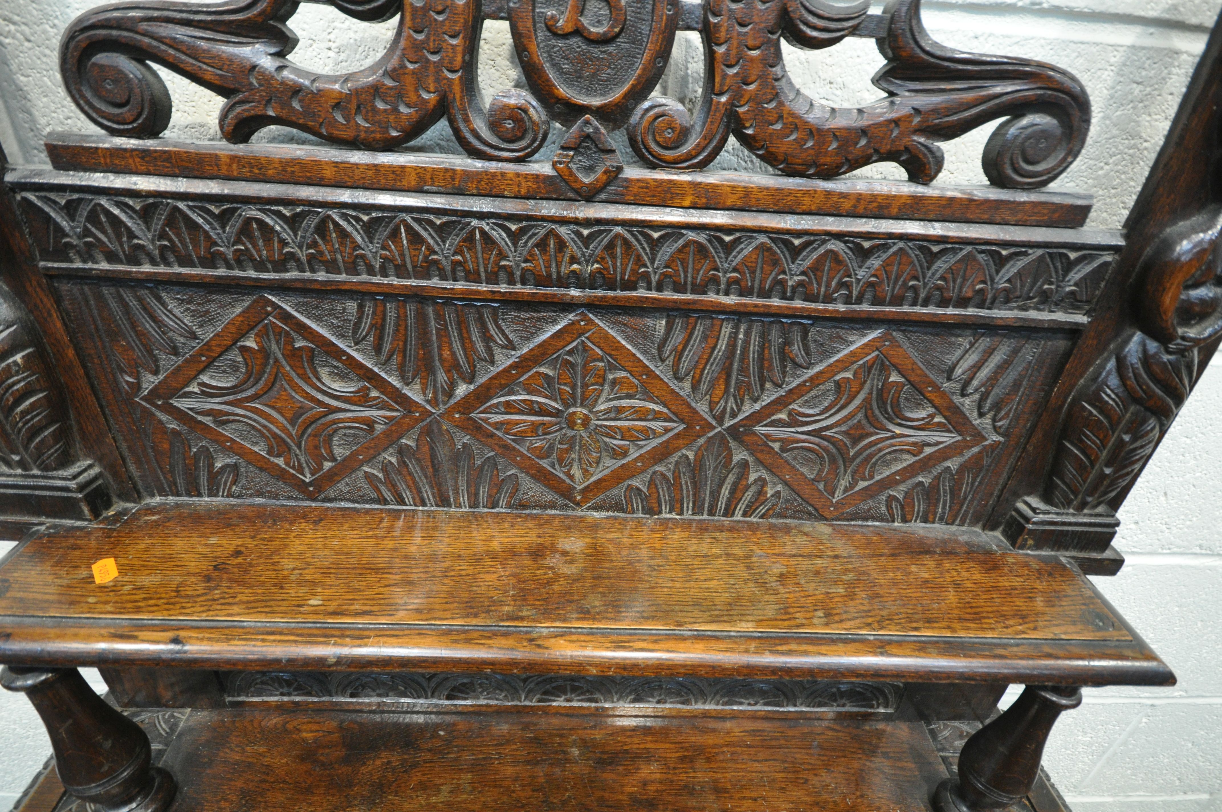 A LATE 19TH/EARLY 20TH CENTURY CARVED OAK SIDE TABLE, the raised back with a single shelf, depicting - Image 5 of 6