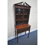 AN EDWARDIAN MAHOGANY GLAZED TWO DOOR BOOKCASE ON STAND, with swan neck pediment with open