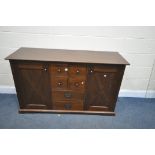 A HARDWOOD SIDEBOARD, with three central drawers, width 148cm x depth 51cm x height 87cm (