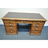 A LATE 19TH/EARLY 20TH CENTURY PITCH PINE PEDESTAL DESK, with brown leather writing surface, and
