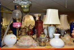 A GROUP OF LAMPS AND SHADES, to include an oil lamp with pink glass reservoir and decorative