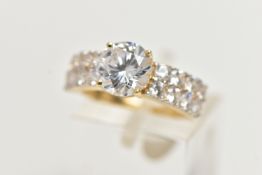 A 14CT YELLOW GOLD, CUBIC ZIRCONIA DRESS RING, centring on a circular cut, colourless cubic