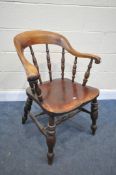 A 19TH CENTURY ELM AND BEECH CAPTAINS CHAIR, with a raised arched back, scrolled arms and turned