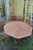 A WOODEN OCTAGONAL FOLDING GARDEN TABLE WITH FOUR MATCHING CHAIRS
