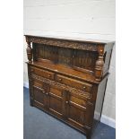 AN OAK LINENFOLD COURT CUPBOARD, with two drawers, width 141cm x depth 49cm x height 144cm (