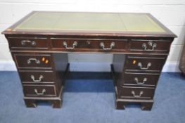 A MAHOGANY PEDESTAL DESK, with a green leather writing surface, and nine drawers, on bracket feet,