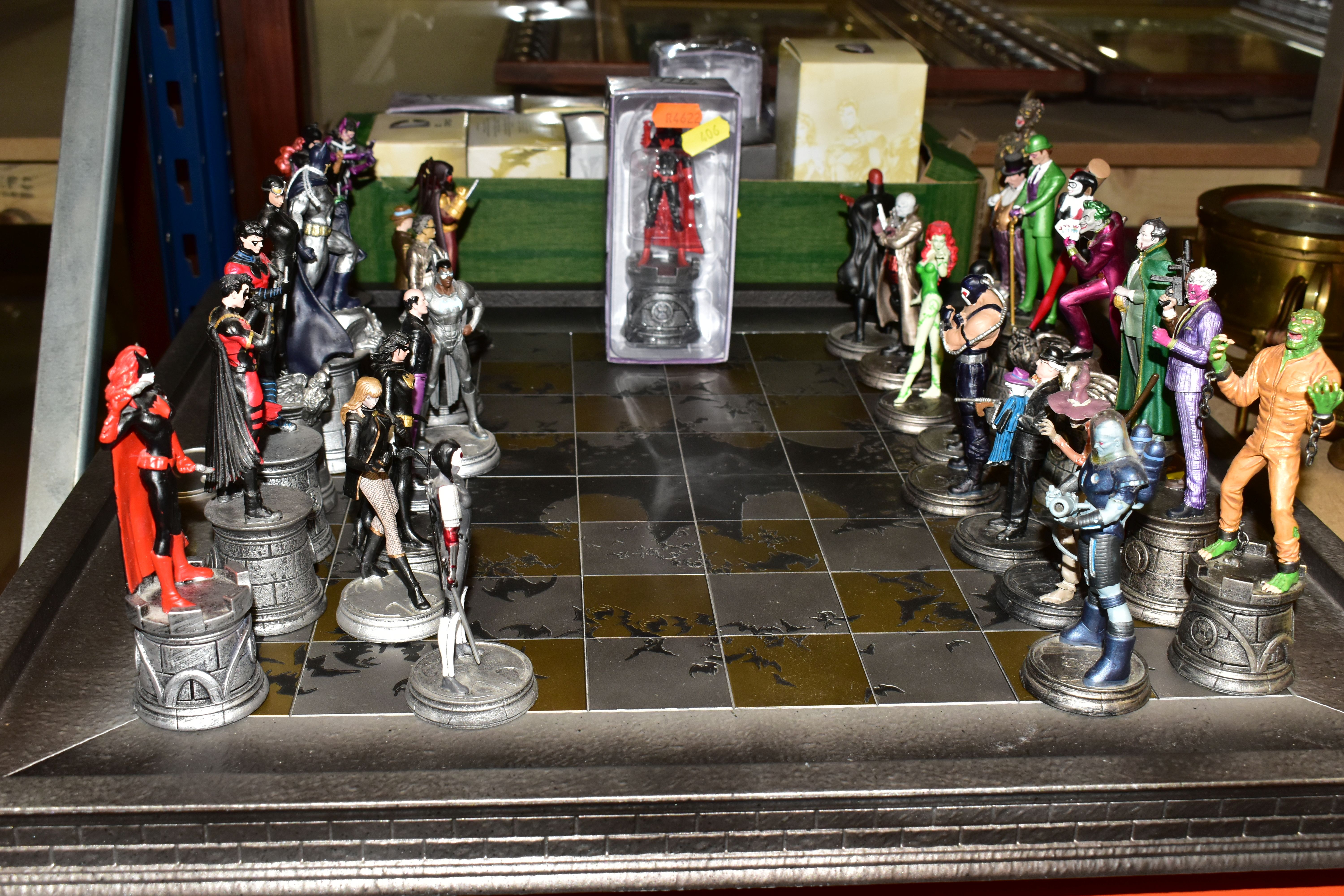 AN EAGLEMOSS D.C. COMICS BATMAN CHESS SET AND BOARD, complete with 32 character pieces, appears in