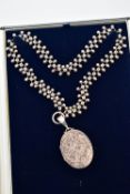 A LATE 19TH CENTURY LOCKET AND CHAIN, oval form silver locket detailed with seven gold fronted fleur