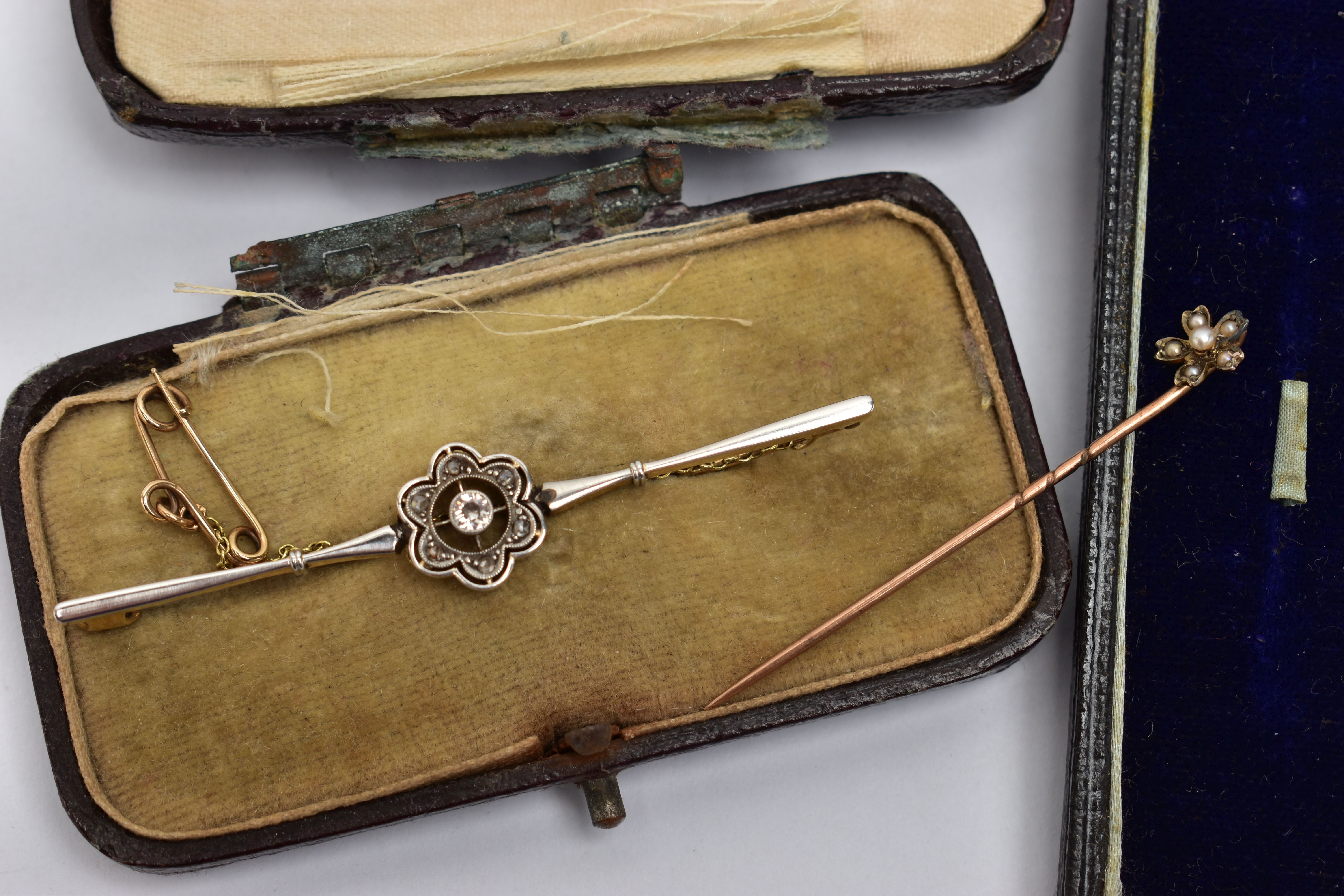 AN EARLY 20TH CENTRURY BAR BROOCH AND STICK PIN, the first a central old cut diamond in a milgrain