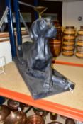 A BLACK FIBREGLASS SCULPTURE OF A DOG, approximate dimensions - height 47cm x length 80cm