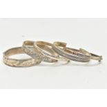 AN ASSORTMENT OF SILVER AND WHITE METAL BANGLES, to include a hinged bangle with floral engraving