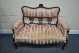 A 19TH CENTURY MAHOGANY SOFA, with carved open fretwork back, on stripped and floral upholstery,