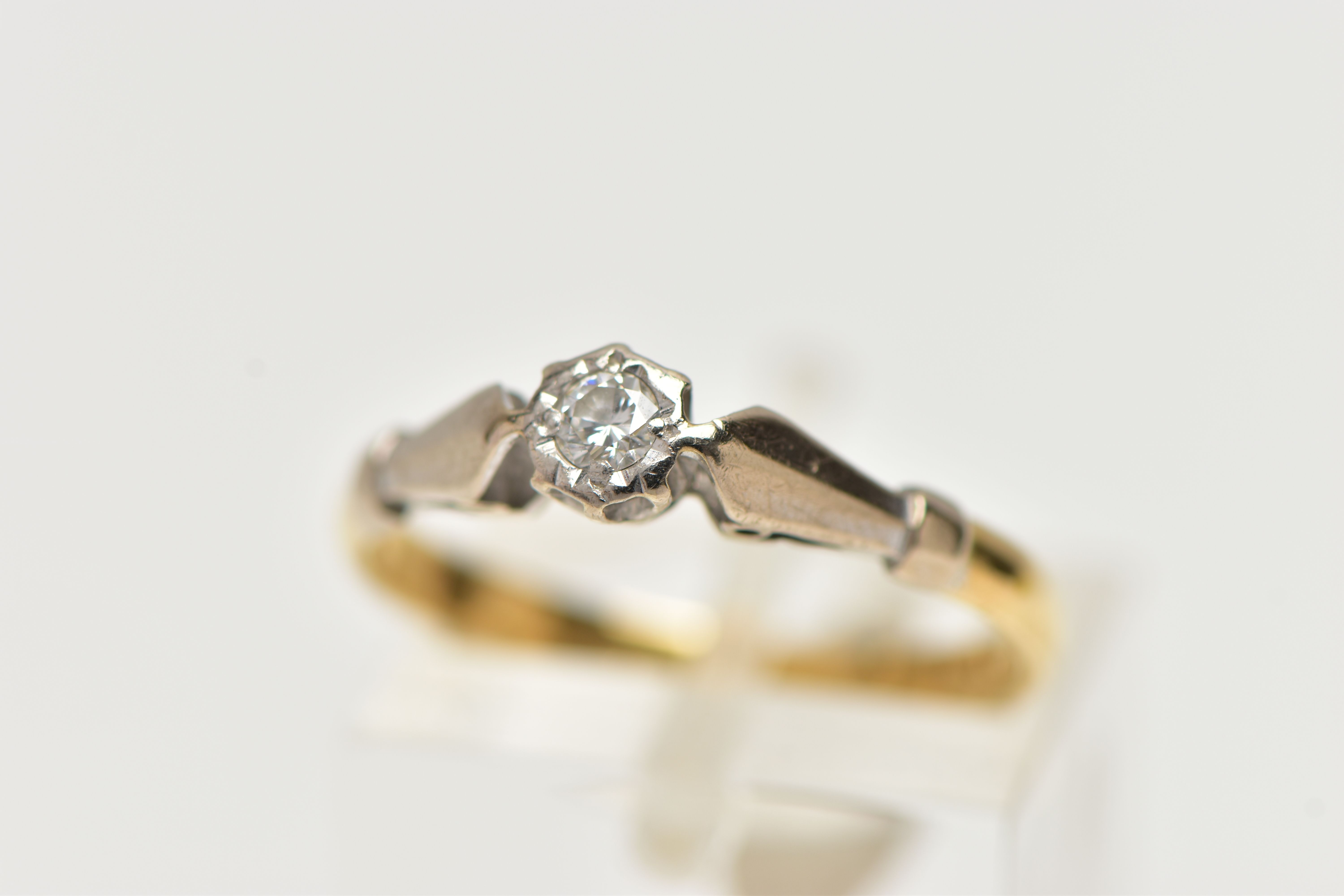 AN 18CT GOLD, SINGLE STONE DIAMOND RING, a round brilliant cut diamond set in a white metal illusion