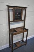 AN OAK HALL STAND, with a central mirror, width 83cm x depth 27cm x height 167cm (condition:-surface