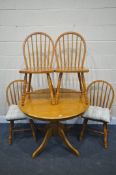 A MODERN BEECH CIRCULAR PEDESTAL DINING TABLE, and four hoop back chairs (condition:-good condition)