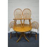 A MODERN BEECH CIRCULAR PEDESTAL DINING TABLE, and four hoop back chairs (condition:-good condition)