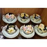 SIX PARAGON TEACUPS AND SAUCERS, the interiors of the cups decorated with flowers on a black ground,