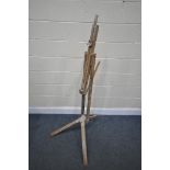 A FOLDING BEECH ARTISTS EASEL (condition:-paint splashes throughout)