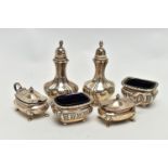 AN ASSORTMENT OF CONDIMENT SETS, to include a pair of Edwardian silver pepperettes, hallmark