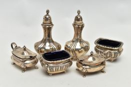 AN ASSORTMENT OF CONDIMENT SETS, to include a pair of Edwardian silver pepperettes, hallmark