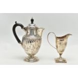 A LATE VICTORIAN SILVER HOT WATER JUG AND A LATE VICTORIAN GEORGIAN STYLE HELMET SHAPED CREAM JUG,