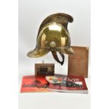 A VICTORIAN BRASS MERRYWEATHER TYPE FIREMAN'S HELMET, with a worn leather and brass chin strap and