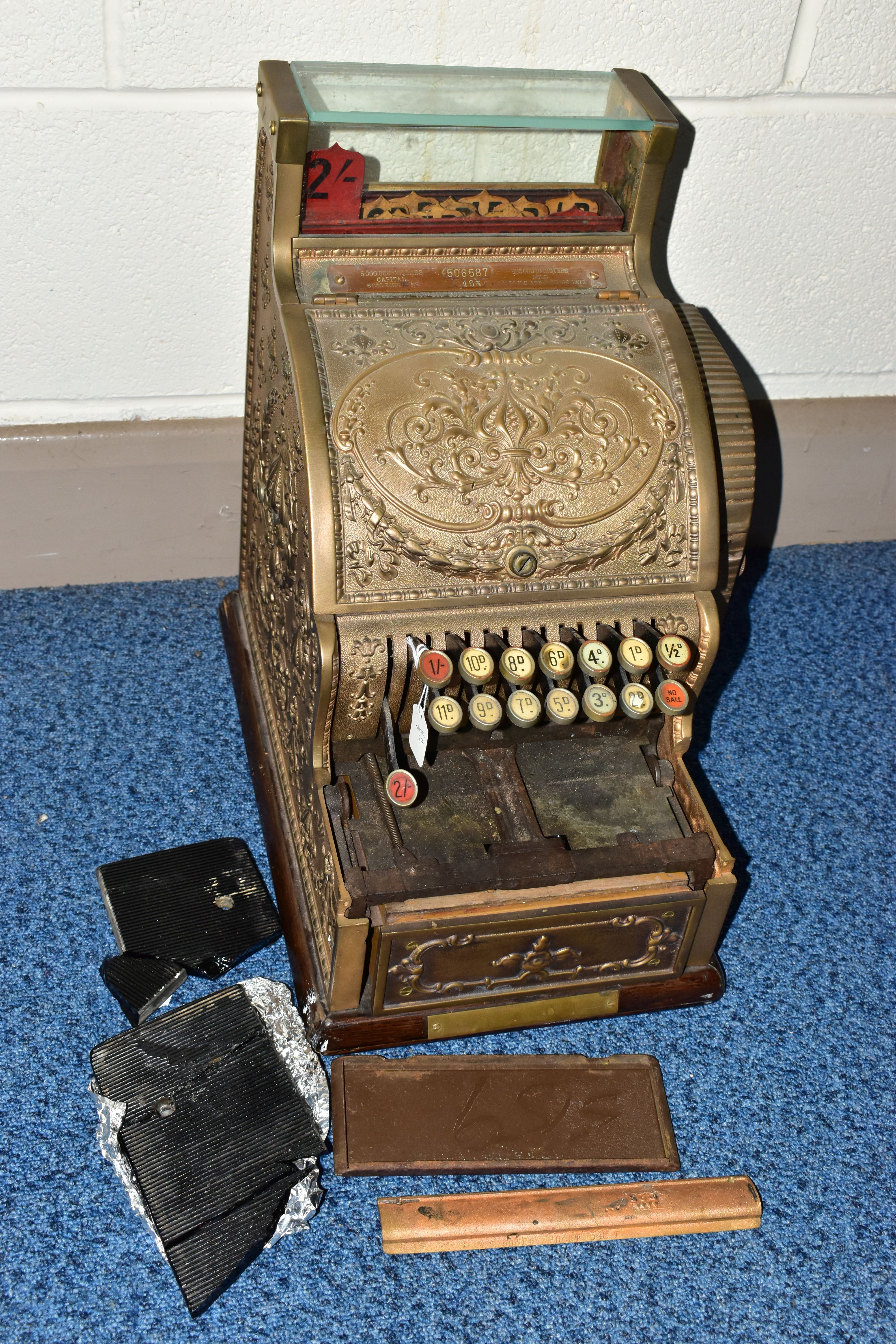 A 20TH CENTURY AMERICAN BRASS CASH REGISTER BY NATIONAL DAYTON OF OHIO, mounted on a wooden