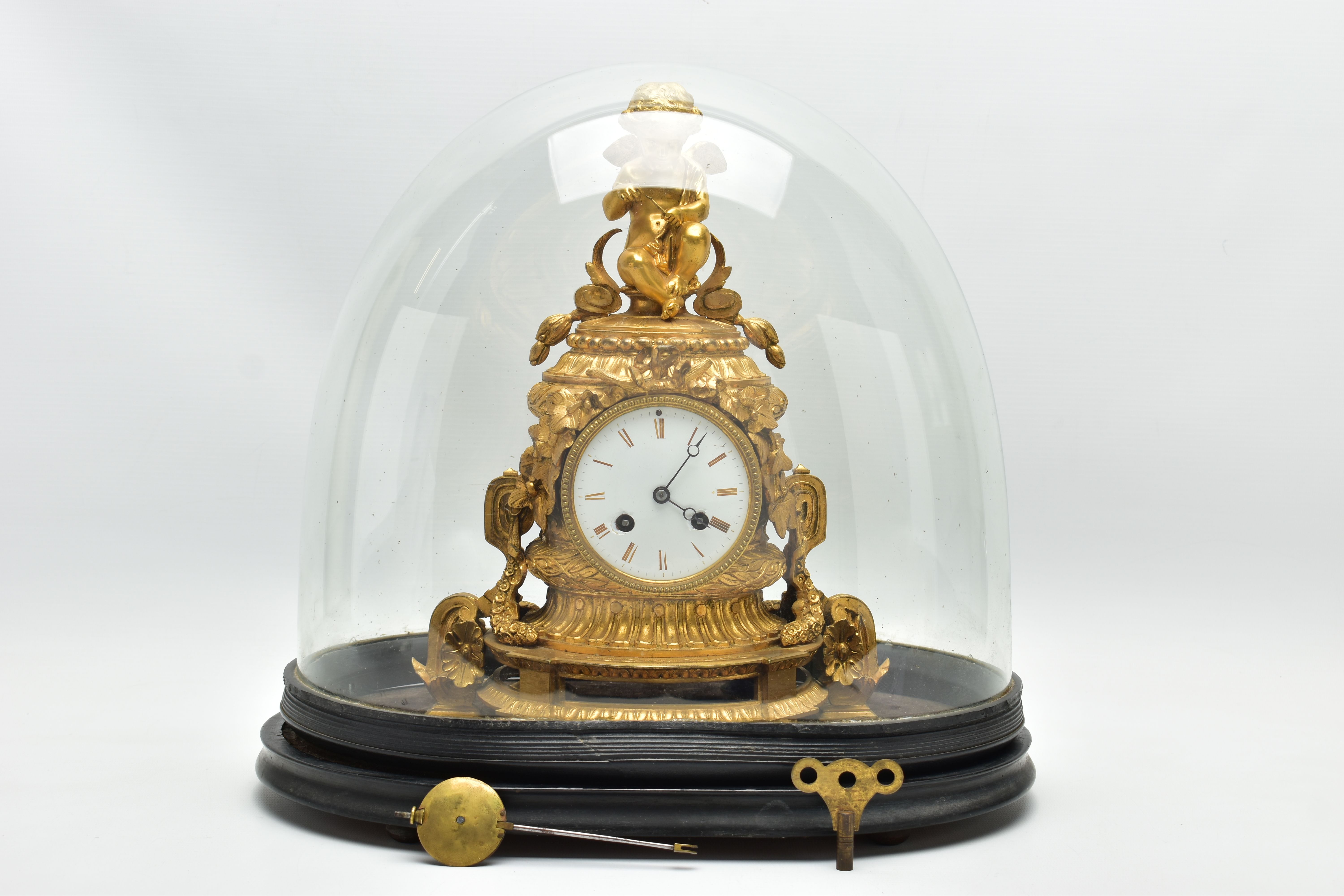 A LATE 19TH CENTURY FRENCH ORMOLU MANTEL CLOCK OF SHAPED CYLINDRICAL FORM, the circular top with