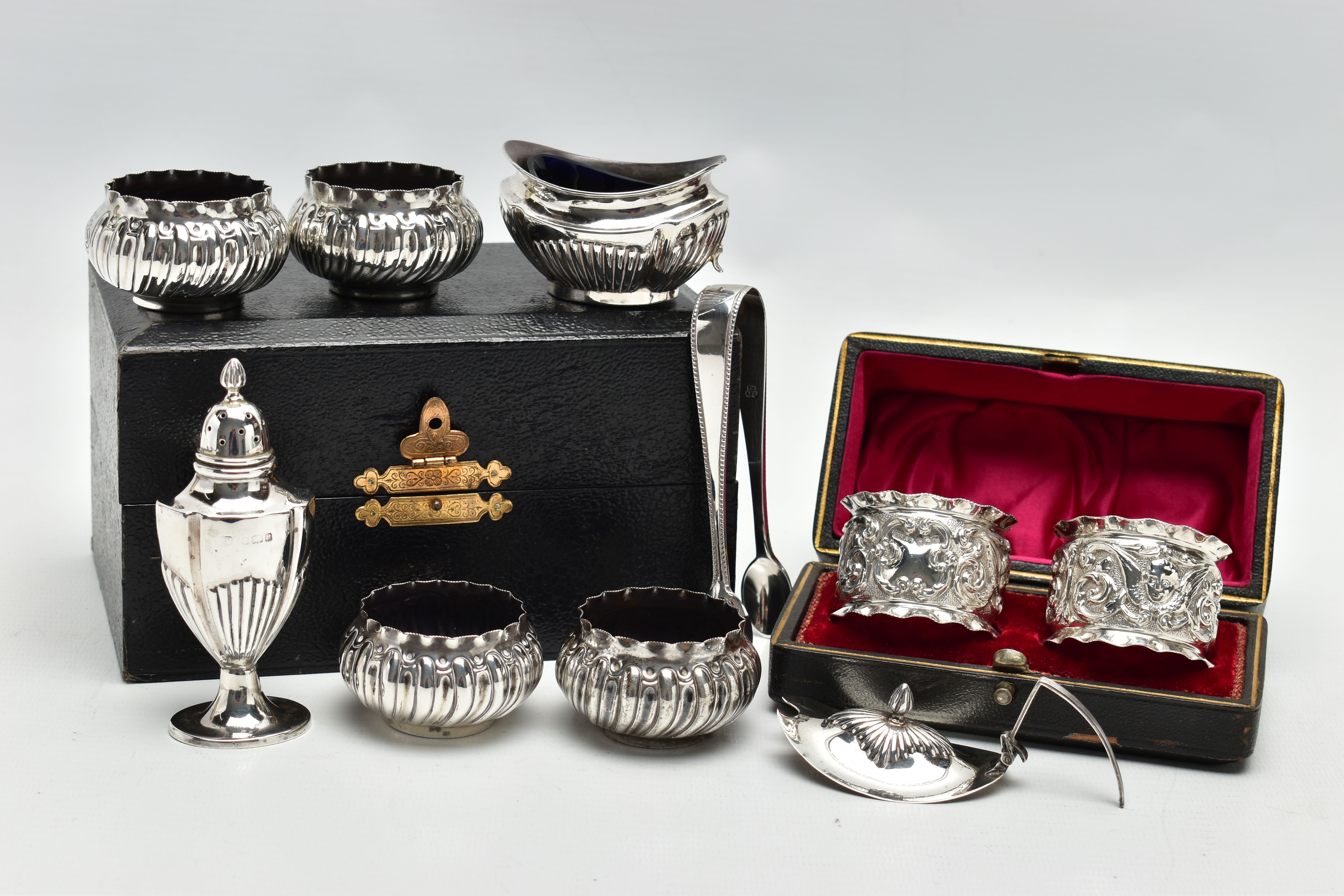 A PARCEL OF LATE VICTORIAN AND 20TH CENTURY SILVER NAPKIN RINGS, SUGAR TONGS AND CRUET ITEMS,