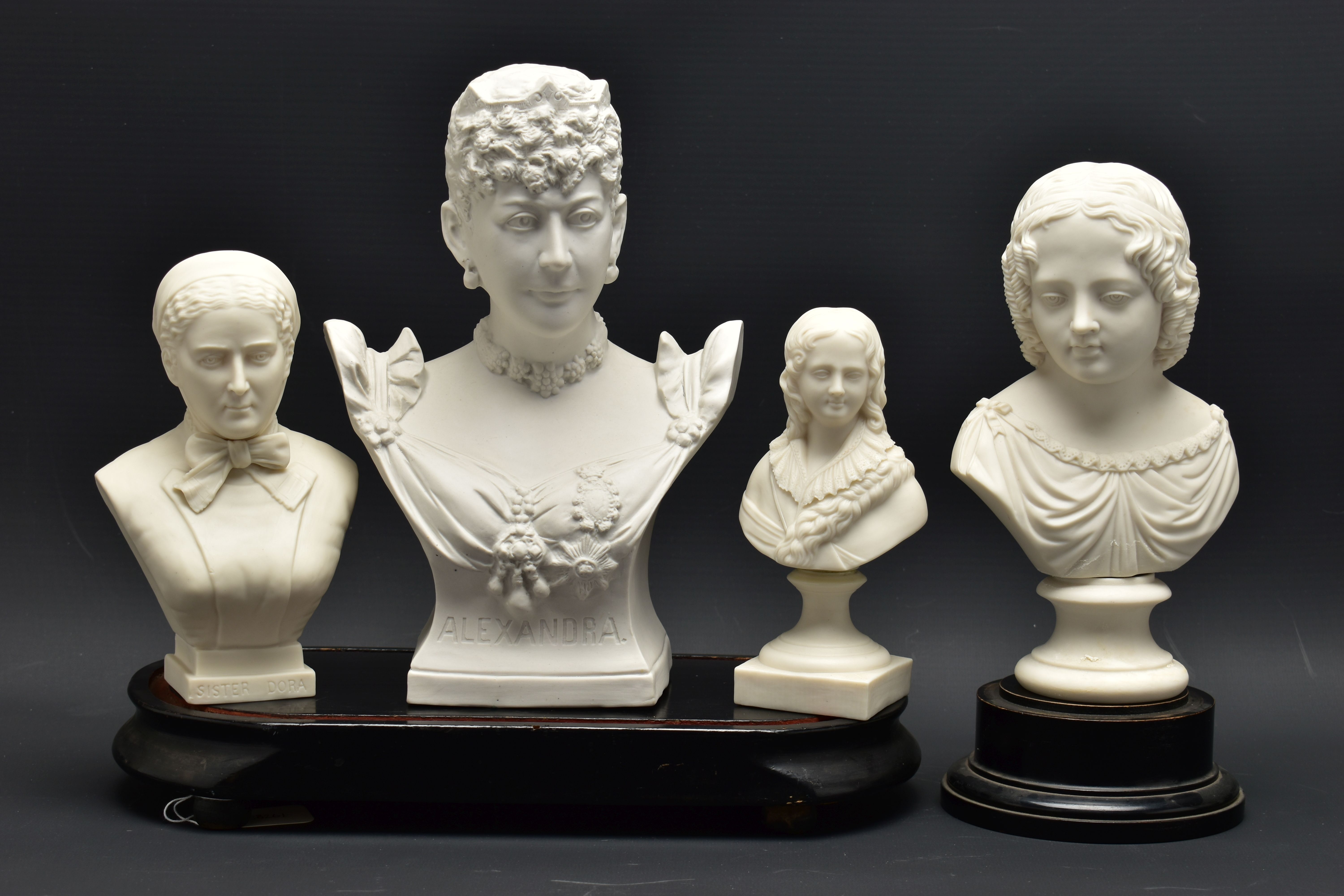 FOUR LATE 19TH AND EARLY 20TH CENTURY PARIAN AND BISQUE BUSTS, comprising a Goss 'Sister Dora',