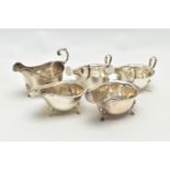 FIVE 20TH CENTURY SILVER SAUCE BOATS OF VARYING DESIGNS, all on three cabriole legs, one with