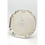AN ELIZABETH II SILVER SALVER OF SHAPED SQUARE FORM, the centre engraved with a logo and