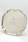 AN ELIZABETH II SILVER SALVER OF SHAPED SQUARE FORM, the centre engraved with a logo and