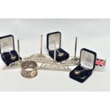 A SET OF FOUR LATE VICTORIAN SILVER MENU HOLDERS, with pierced and cast scrolled design, maker Henry