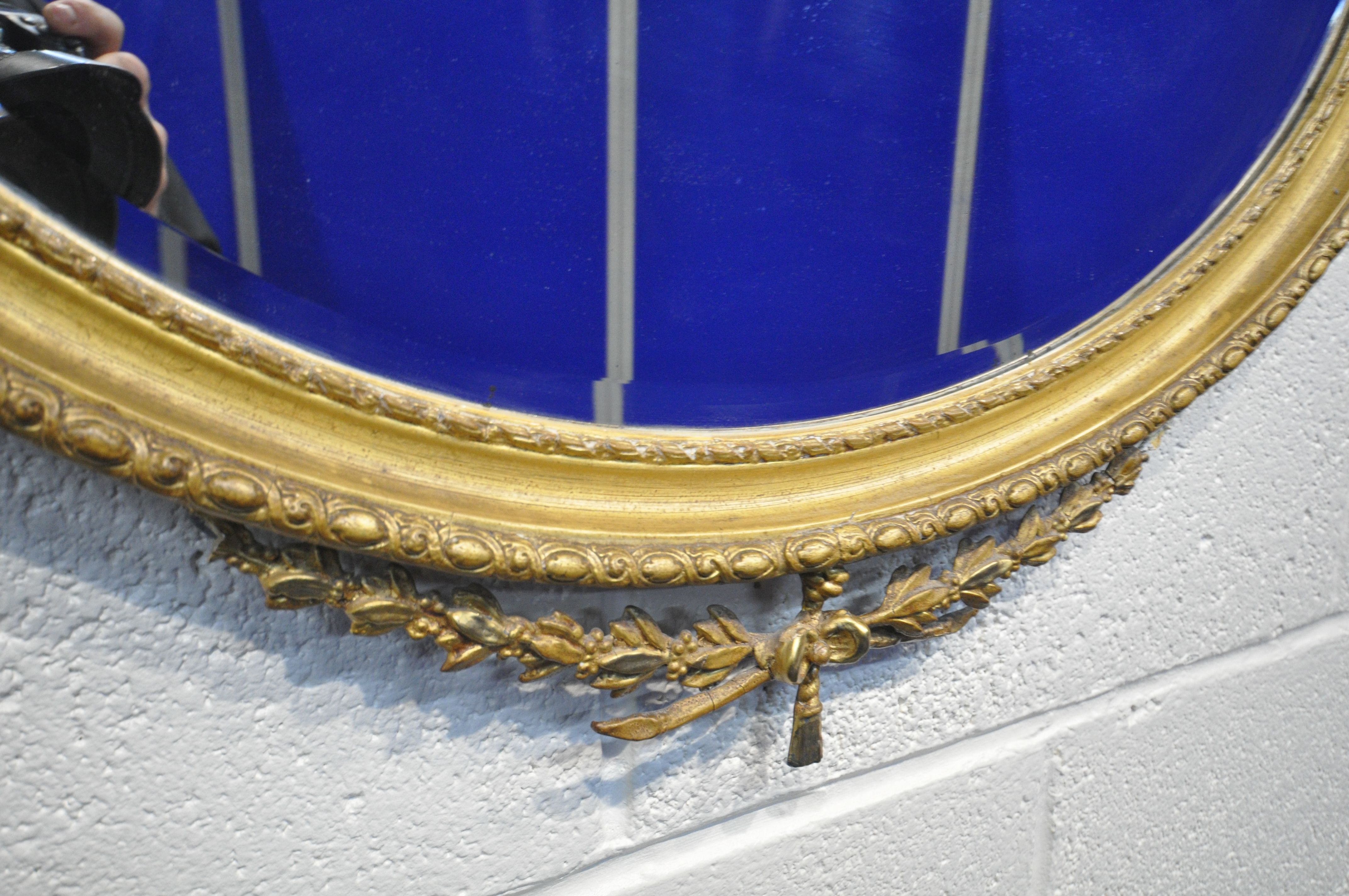 A NEOCLASSICAL GILTWOOD OVAL WALL MIRROR, 19th century, bevelled edge plate, with central surmount - Image 5 of 10