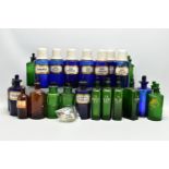 A COLLECTION OF TWENTY THREE COLOURED GLASS PHARMACY BOTTLES, comprising ten blue cylindrical