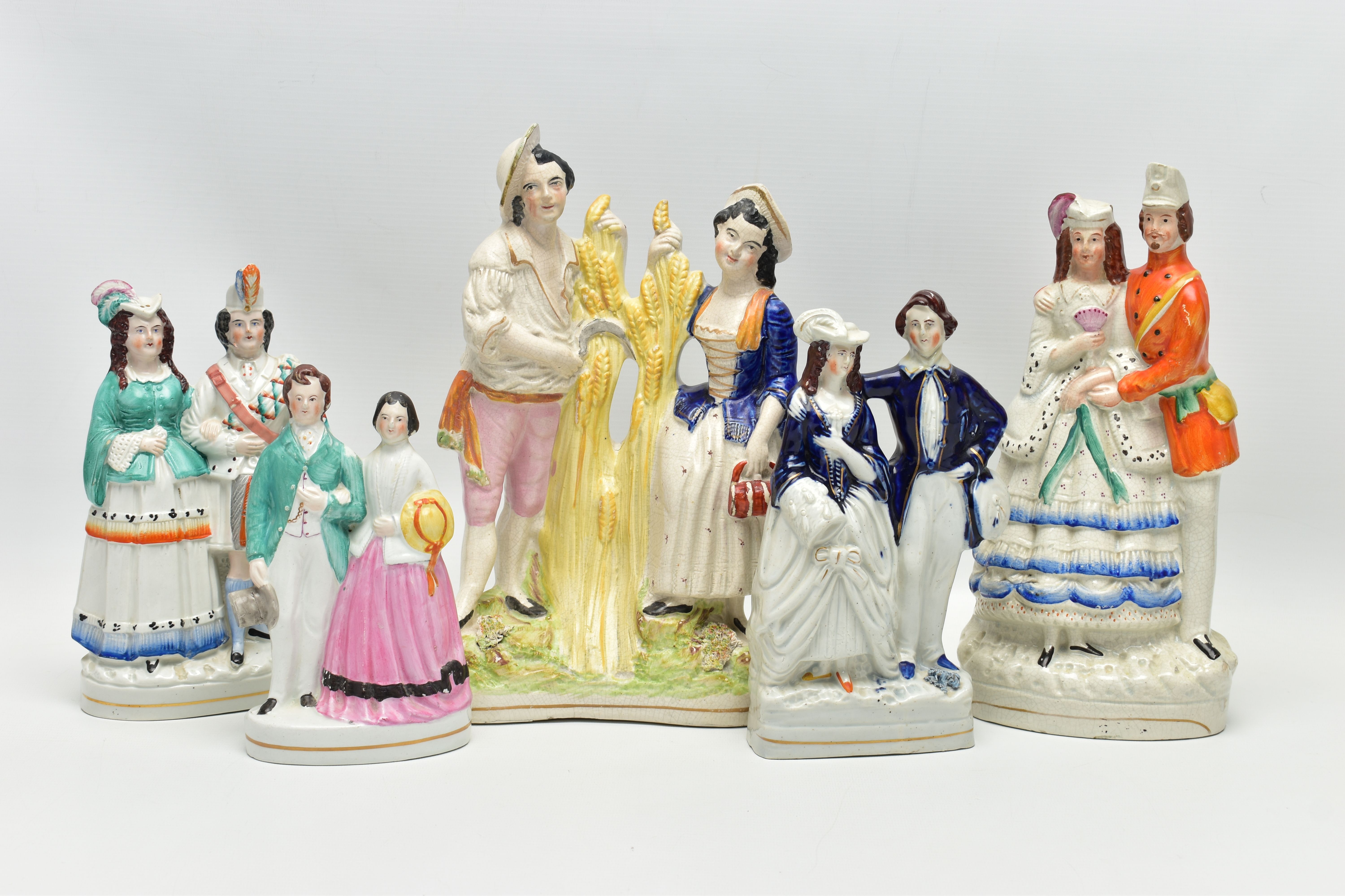 FIVE VICTORIAN STAFFORDSHIRE POTTERY FIGURE GROUPS OF COUPLES, comprising a harvest scene, height