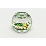 A PERTHSHIRE GLASS PAPERWEIGHT, containing pale yellow buds and flowers on green stalks and 'P' in a