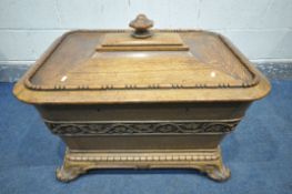 A VICTORIAN OAK CELLARETTE, of sarcophagus form, the lid with a large octagonal handle, enclosing