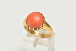 AN EDWARDIAN 18CT YELLOW GOLD CORAL RING, the coral cabochon measuring approximately 11.5mm diameter