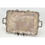 AN EDWARDIAN SILVER TWIN HANDLED TRAY OF RECTANGULAR FORM WITH PIE CRUST AND SHELL RIMS, plain